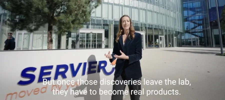 Charli hosting Servier's 'World Quality Week' internal video outside the Servier headquarters